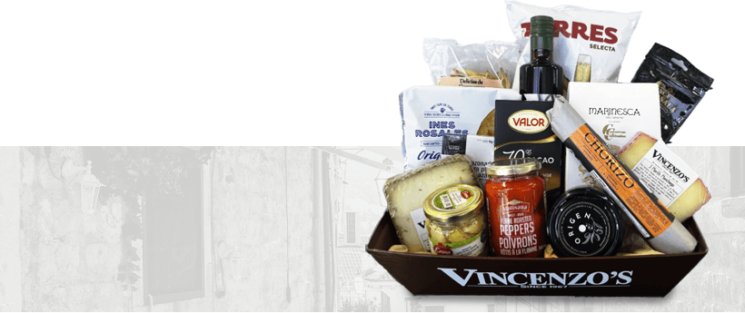 Vincenzo's taste of Spain gift basket on Spanish building background.